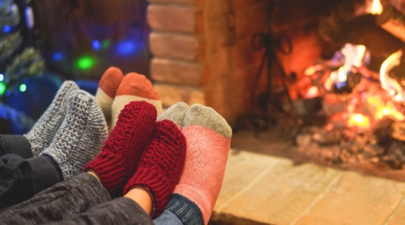Family with feet up by the fireplace | Watershed Cabin Rentals Near Bryson City NC