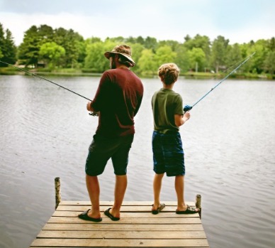 Father and son fishing on lake | Watershed Cabins Bryson City Cabin Rentals