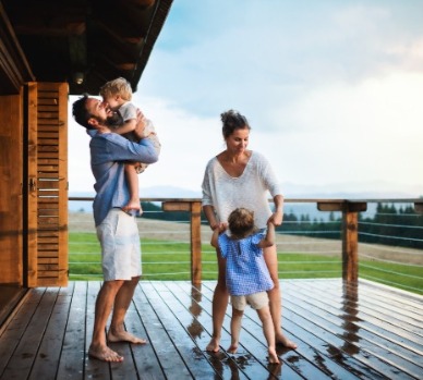 Family on deck of mountain cabin rental | Watershed Cabins Bryson City Cabin Rentals