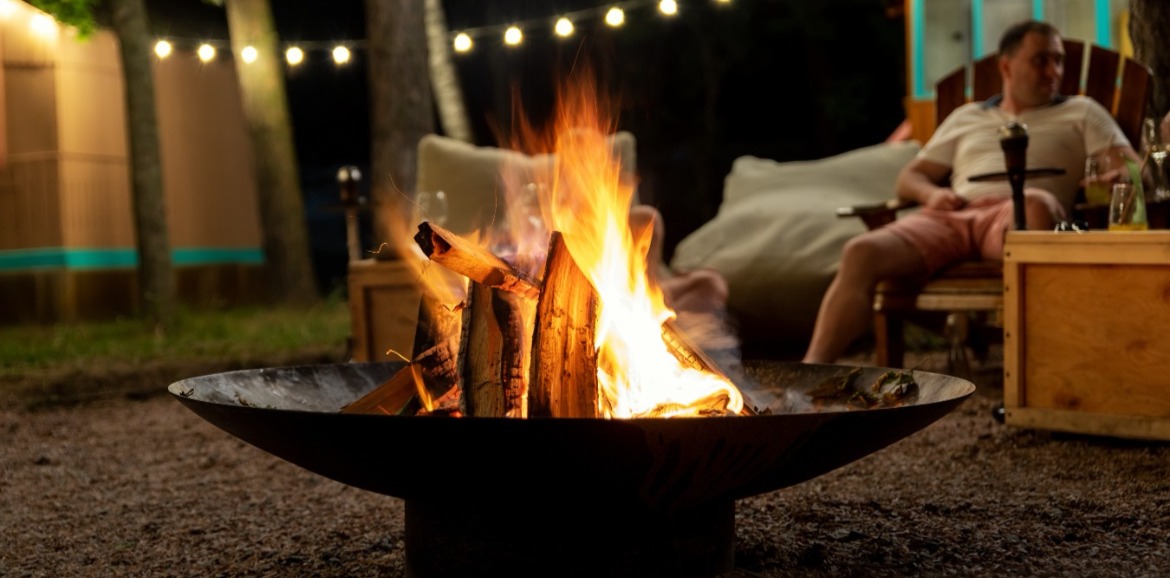 Man sitting outside by the firepit | Watershed Cabins Bryson City Vacation Rentals