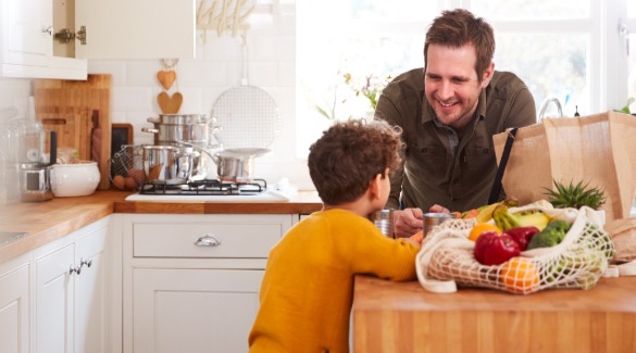 Father and son unpacking groceries from a bag | Watershed Cabin Rentals Near Bryson City NC