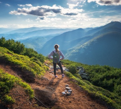 Woman hiking a mountain path | Watershed Cabins NC Smoky Mountain Rentals