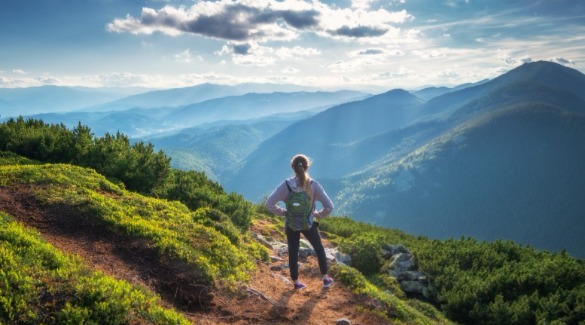 Woman standing on mountain looking out at clouds and sky | Watershed Cabins Mother's Day Bryson City Rentals